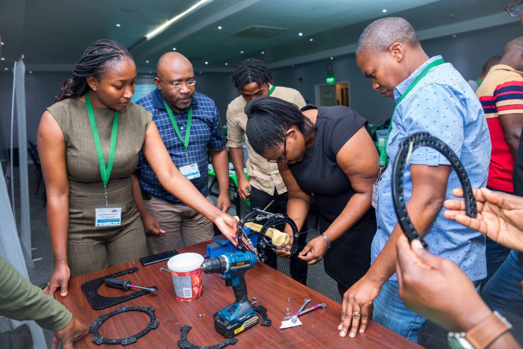 Attendees practice setting up the Ilizarov frame.